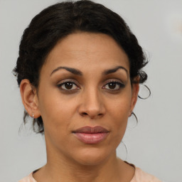 Joyful black young-adult female with medium  brown hair and brown eyes