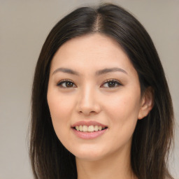 Joyful asian young-adult female with long  brown hair and brown eyes