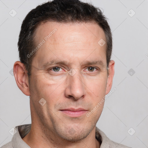 Joyful white adult male with short  brown hair and grey eyes