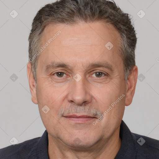 Joyful white middle-aged male with short  brown hair and brown eyes