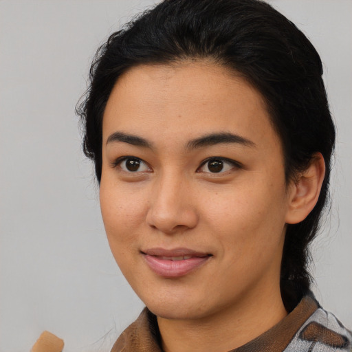 Joyful asian young-adult female with medium  black hair and brown eyes