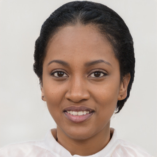 Joyful black young-adult female with short  black hair and brown eyes