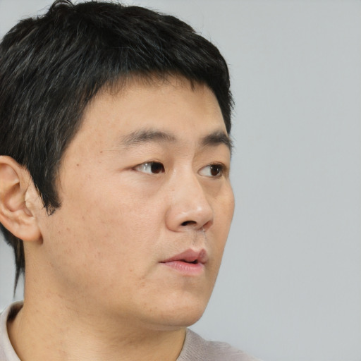 Neutral asian young-adult male with short  brown hair and brown eyes