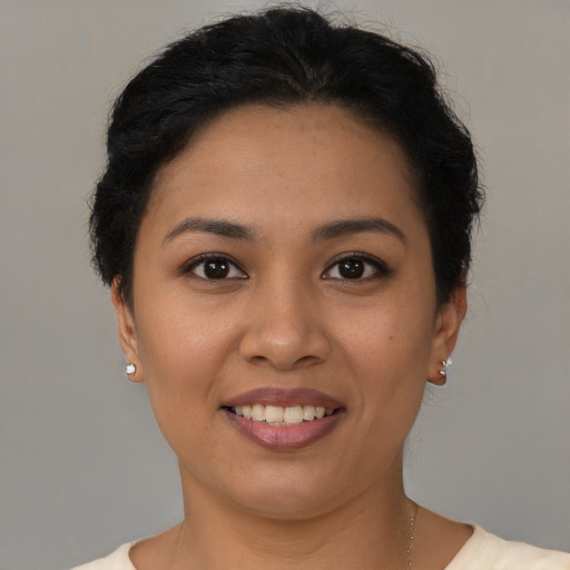 Joyful latino young-adult female with short  brown hair and brown eyes