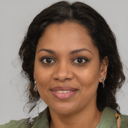 Joyful black young-adult female with medium  brown hair and brown eyes