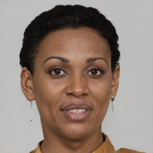 Joyful latino adult female with short  brown hair and brown eyes