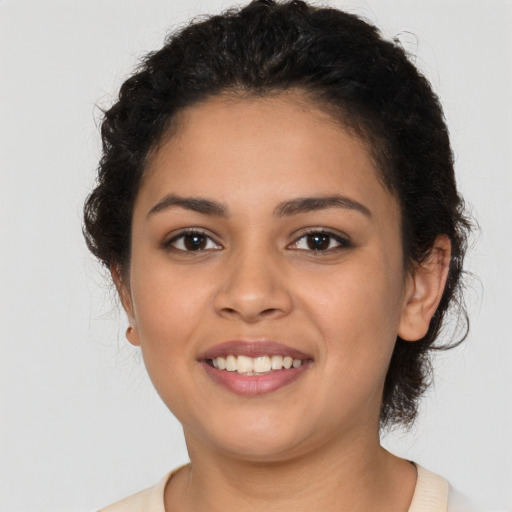 Joyful latino young-adult female with short  brown hair and brown eyes