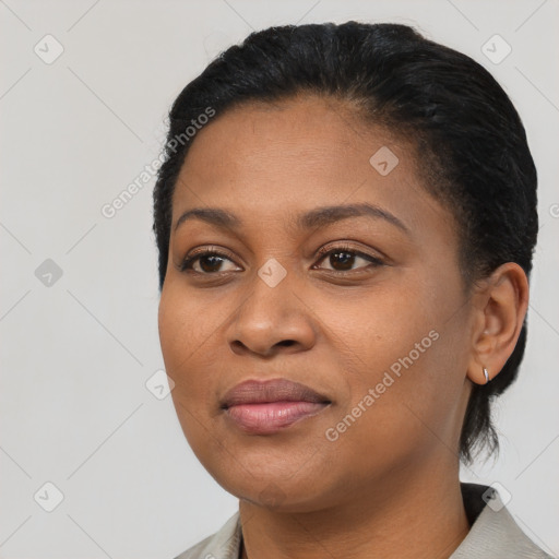 Joyful black young-adult female with short  black hair and brown eyes