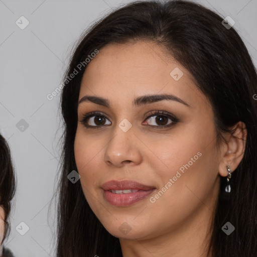 Joyful latino young-adult female with long  brown hair and brown eyes