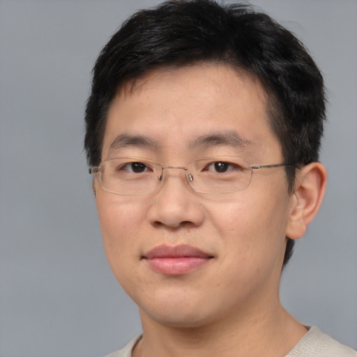 Joyful asian adult male with short  brown hair and brown eyes
