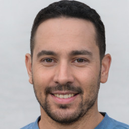 Joyful white young-adult male with short  black hair and brown eyes