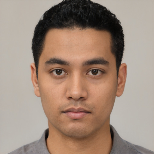 Neutral latino young-adult male with short  black hair and brown eyes