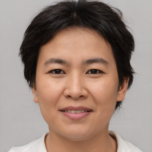 Joyful asian young-adult female with short  brown hair and brown eyes