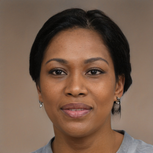 Joyful black adult female with medium  black hair and brown eyes