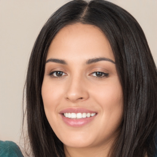 Joyful white young-adult female with long  black hair and brown eyes