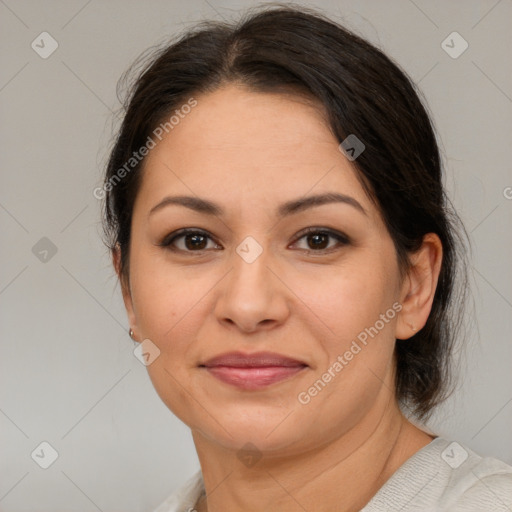 Joyful latino adult female with medium  brown hair and brown eyes