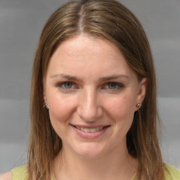 Joyful white young-adult female with medium  brown hair and grey eyes