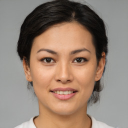 Joyful asian young-adult female with medium  brown hair and brown eyes