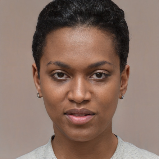 Joyful black young-adult female with short  black hair and brown eyes