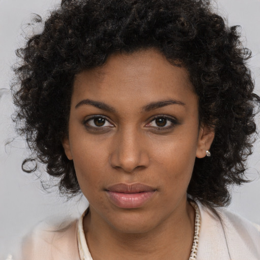 Neutral black young-adult female with medium  brown hair and brown eyes