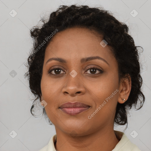 Joyful black adult female with short  brown hair and brown eyes