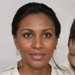 Joyful black young-adult female with medium  brown hair and brown eyes