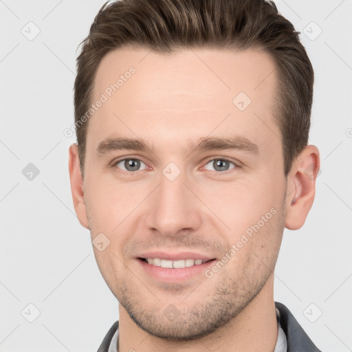 Joyful white young-adult male with short  brown hair and grey eyes