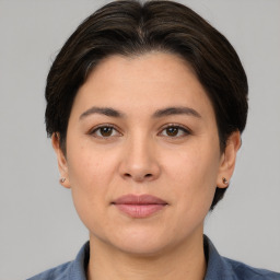 Joyful white adult female with medium  brown hair and brown eyes