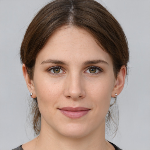 Joyful white young-adult female with medium  brown hair and grey eyes
