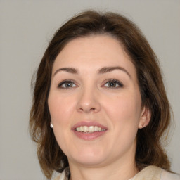 Joyful white young-adult female with medium  brown hair and brown eyes