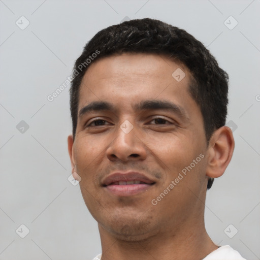 Joyful latino young-adult male with short  black hair and brown eyes