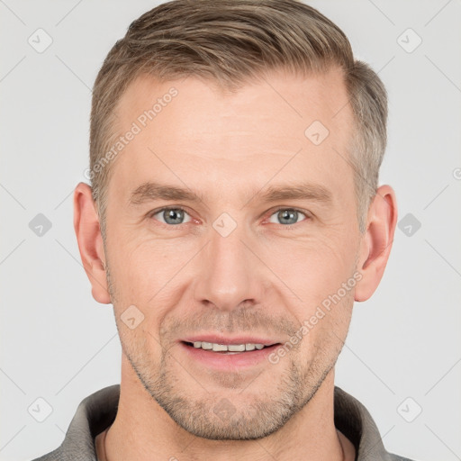 Joyful white adult male with short  brown hair and grey eyes