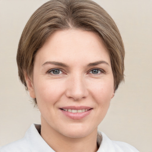 Joyful white young-adult female with short  brown hair and grey eyes