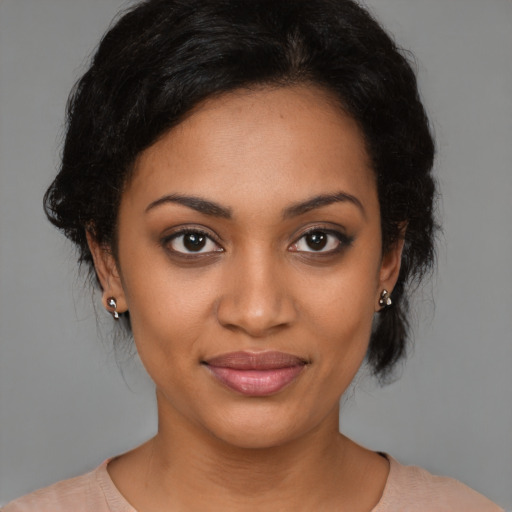 Joyful black young-adult female with medium  brown hair and brown eyes