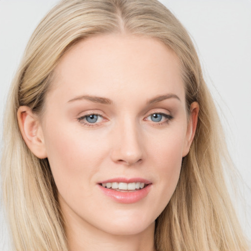 Joyful white young-adult female with long  brown hair and blue eyes