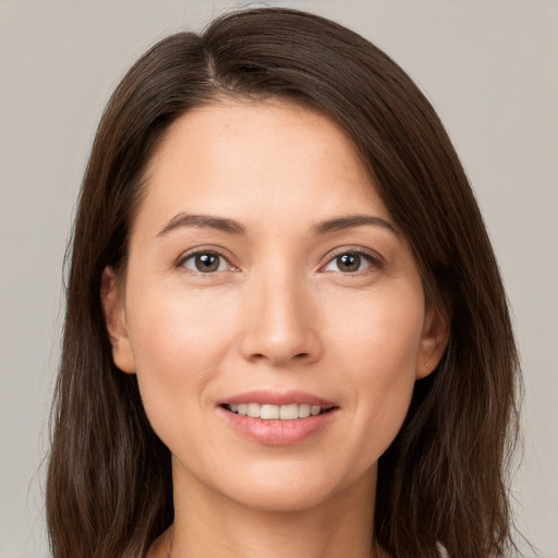 Joyful white young-adult female with long  brown hair and brown eyes