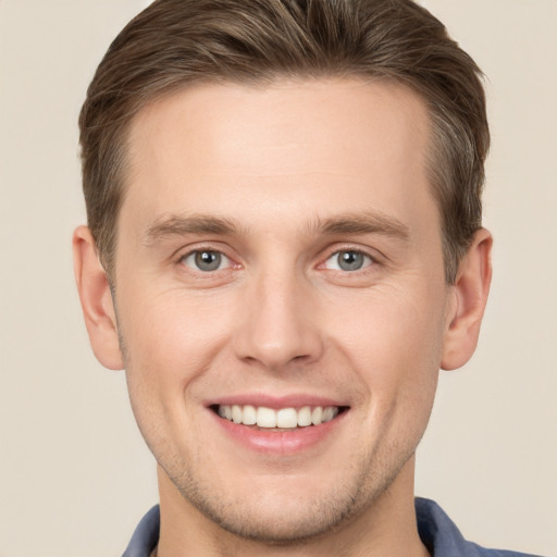 Joyful white young-adult male with short  brown hair and brown eyes