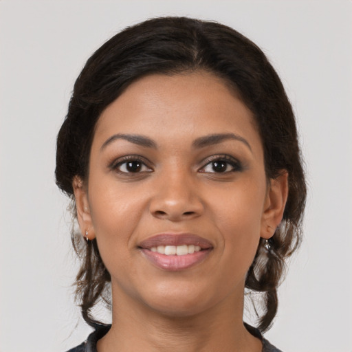 Joyful latino young-adult female with medium  brown hair and brown eyes