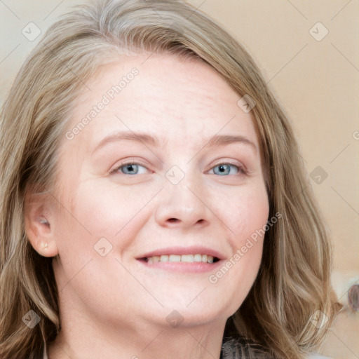 Joyful white young-adult female with long  brown hair and blue eyes