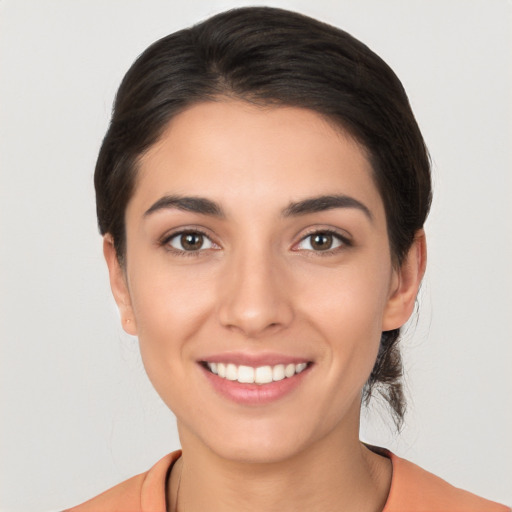 Joyful white young-adult female with medium  brown hair and brown eyes