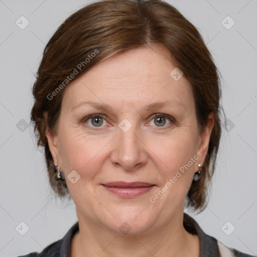 Joyful white adult female with medium  brown hair and grey eyes