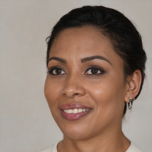 Joyful black young-adult female with medium  brown hair and brown eyes