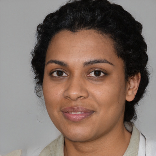 Joyful black young-adult female with medium  black hair and brown eyes