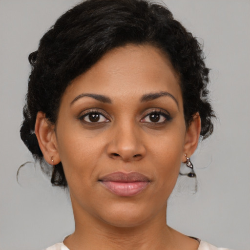 Joyful black young-adult female with short  brown hair and brown eyes