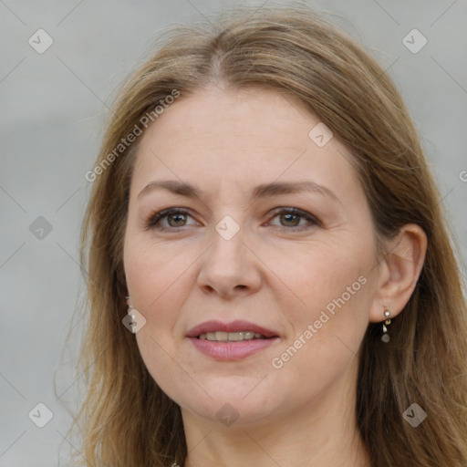 Joyful white adult female with long  brown hair and brown eyes