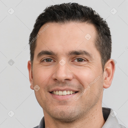 Joyful white young-adult male with short  brown hair and brown eyes