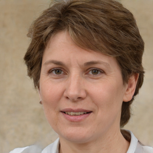 Joyful white adult female with medium  brown hair and brown eyes