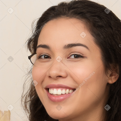 Joyful white young-adult female with long  brown hair and brown eyes