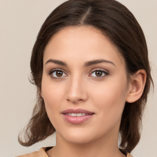 Joyful white young-adult female with medium  brown hair and brown eyes