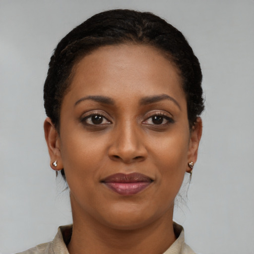 Joyful black young-adult female with short  brown hair and brown eyes